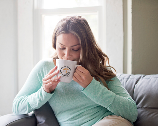 Woman Sipping Delicious Golden Cocoa Hot Chocolate In A Terra Powders Mug