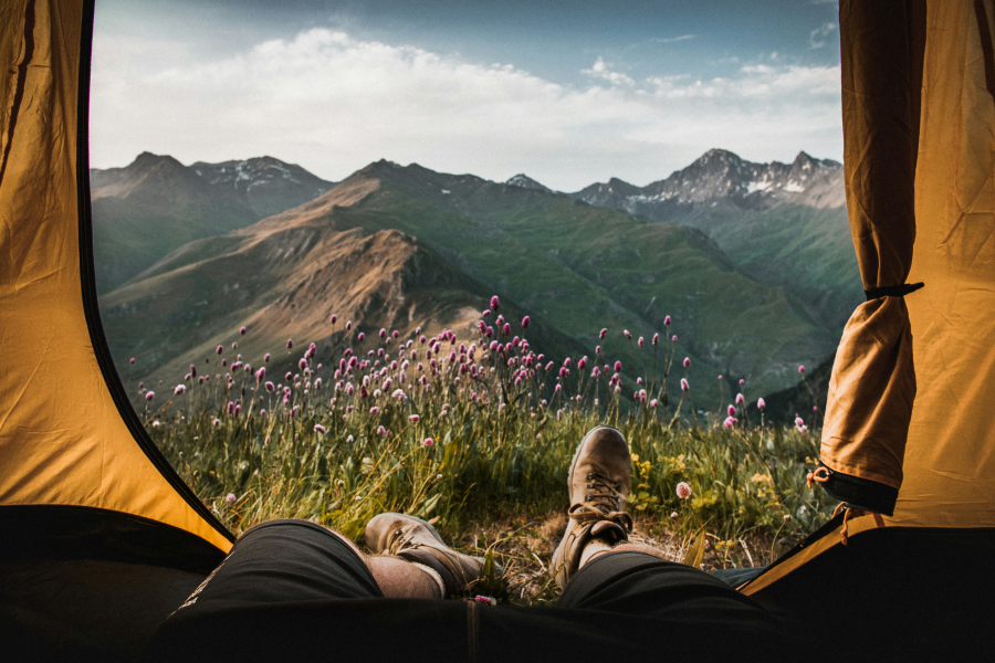 Relaxing In A Tent While Camping In The Mountains