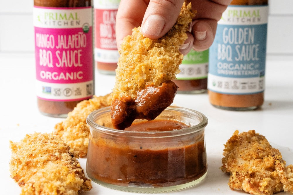 Dipping Air Fryer Ranch Chicken Tenders In Organic Primal Kitchen BBQ Sauces