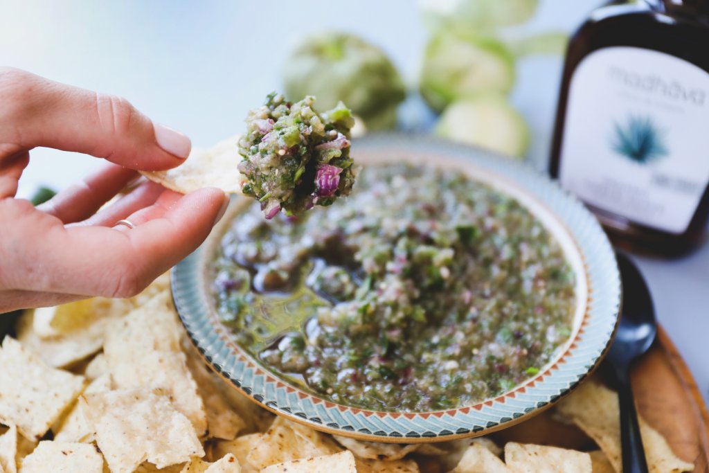 Dipping A Chip Into Roasted Jalapeno Agave Salsa Made With Madhava Organic Amber Blue Agave