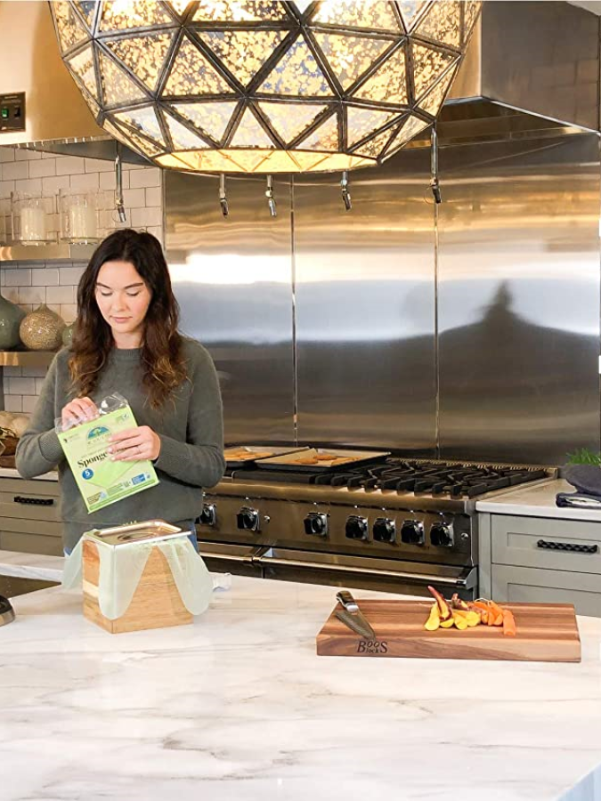 Woman Cleaning Kitchen With If You Care Brand Green Natural Cloth Sponges