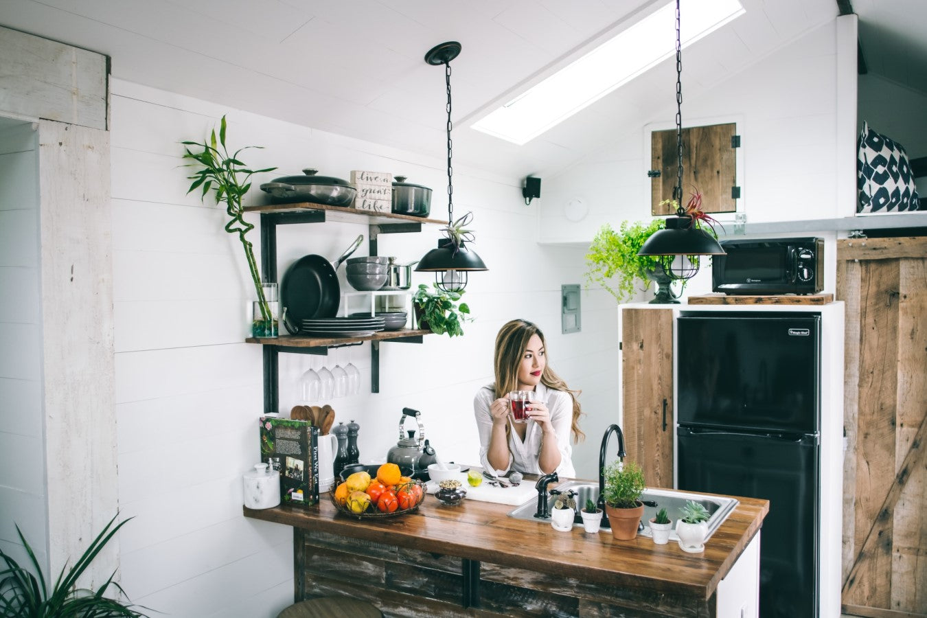 Woman In Clean Eco Friendly Kitchen With Sign Live A Great Life